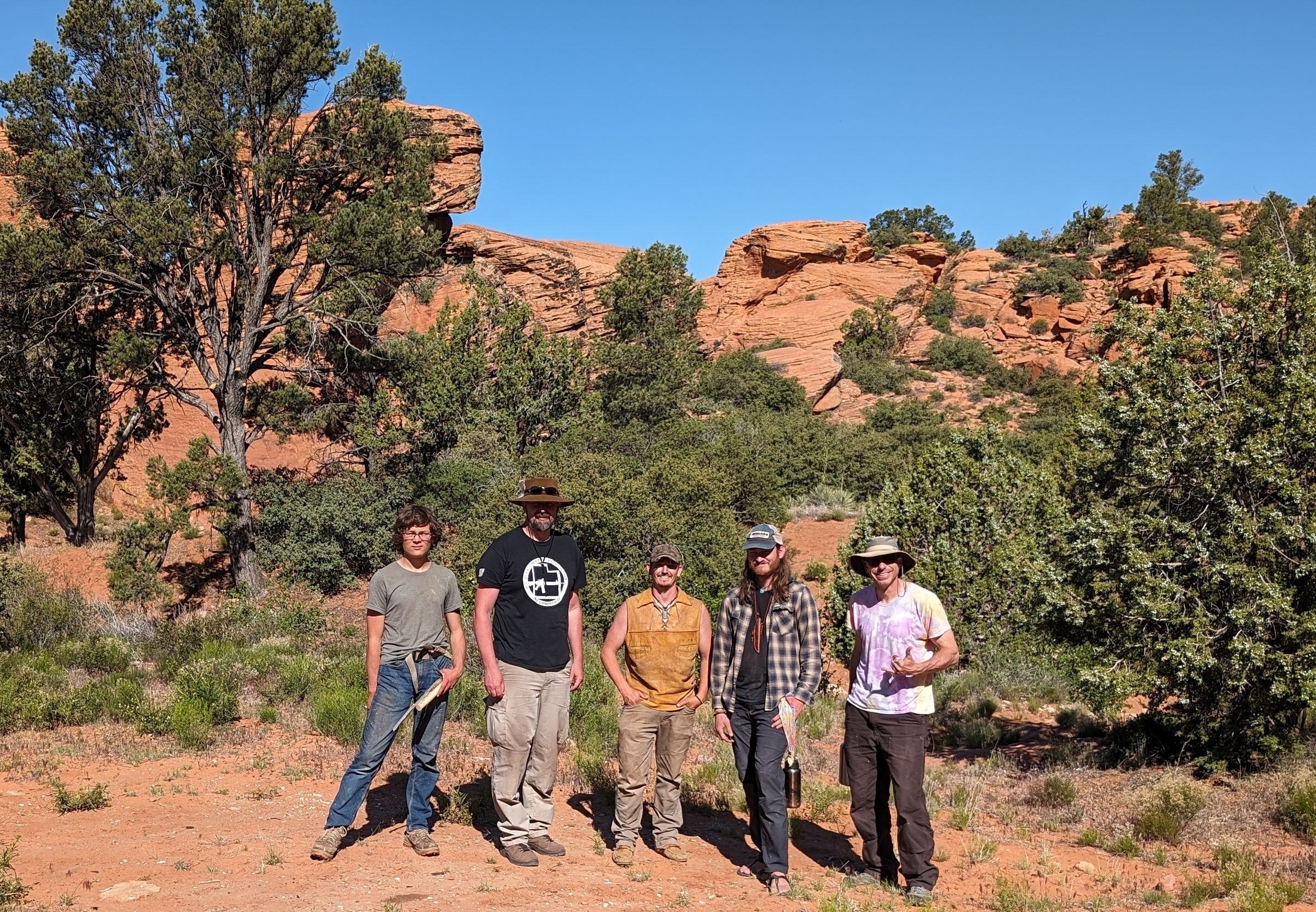 Group posing in a red rock desert landscape